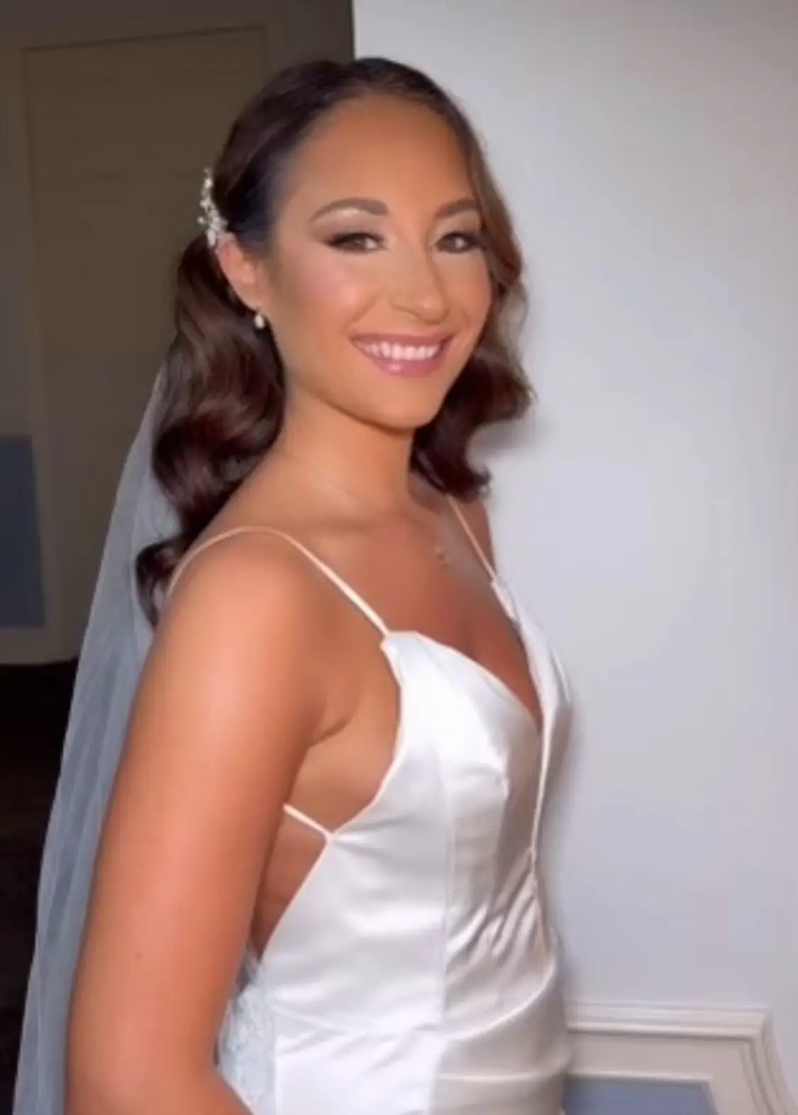 A woman in a white bridal gown with a veil poses indoors, smiling at the camera. | Envy Studio, Lancaster, PA